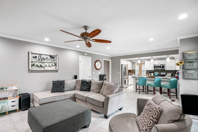 living area featuring ceiling fan, ornamental molding, and light tile patterned floors