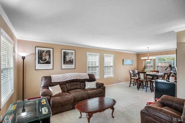 living room featuring baseboards, a notable chandelier, ornamental molding, and carpet