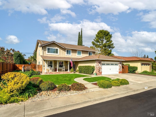 view of front of house featuring concrete driveway, a front lawn, fence, and an attached garage