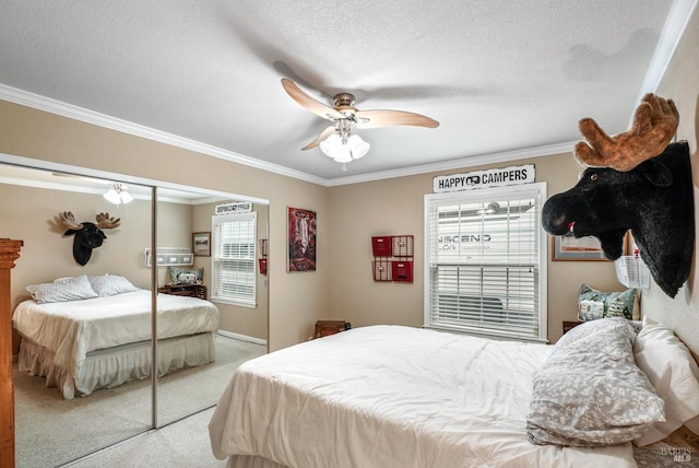 carpeted bedroom with a closet, ornamental molding, and a textured ceiling