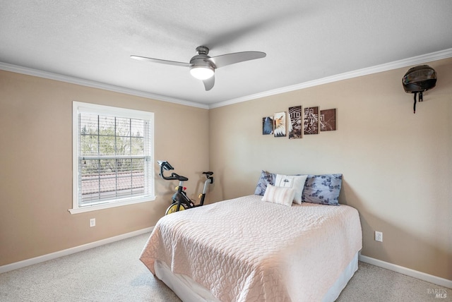 bedroom with baseboards, ceiling fan, crown molding, and carpet floors
