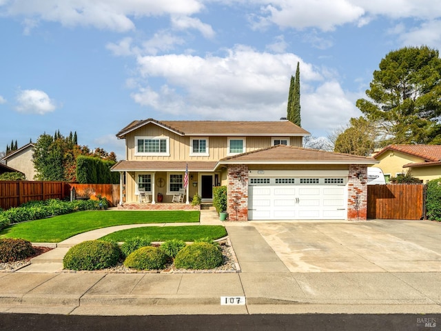 view of front facade featuring fence, board and batten siding, driveway, a front yard, and a garage