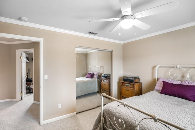 bedroom with crown molding, a closet, carpet floors, baseboards, and visible vents