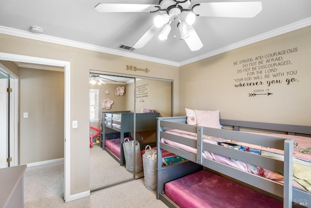 carpeted bedroom featuring a closet, visible vents, crown molding, baseboards, and ceiling fan