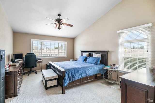 bedroom featuring lofted ceiling, a ceiling fan, and light colored carpet