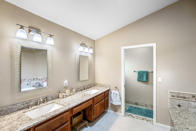 bathroom featuring double vanity, a sink, baseboards, and lofted ceiling
