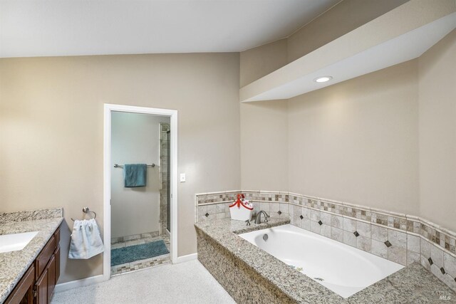 bathroom with a shower stall, vanity, and a bath