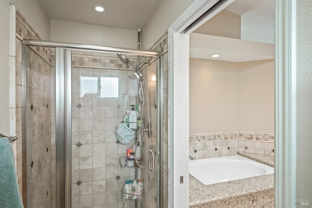 bathroom with a garden tub and a shower stall