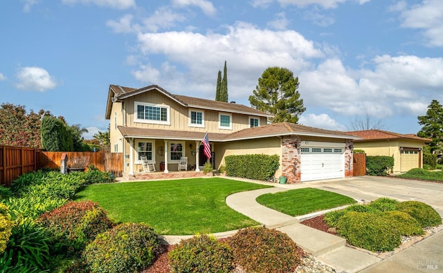 view of front of property with a front lawn, an attached garage, fence, and concrete driveway