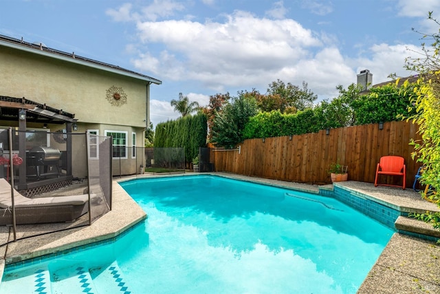 view of pool featuring a fenced backyard, a fenced in pool, and a patio area