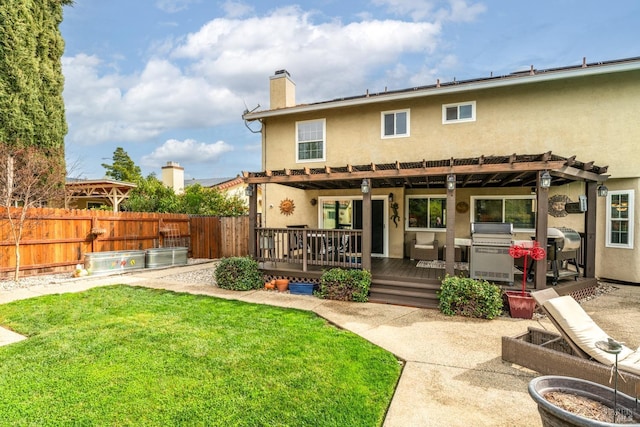 back of house featuring a pergola, stucco siding, fence, and a yard