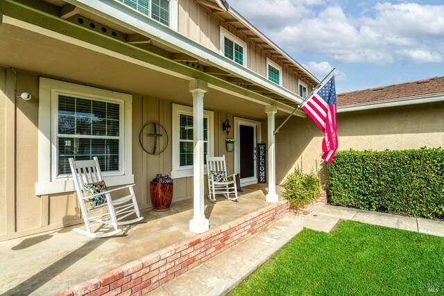 view of exterior entry featuring covered porch