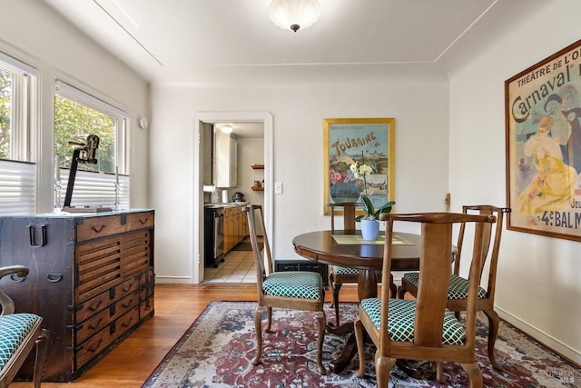dining room with light wood finished floors and baseboards
