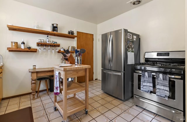 kitchen with stainless steel appliances, light tile patterned floors, visible vents, and open shelves
