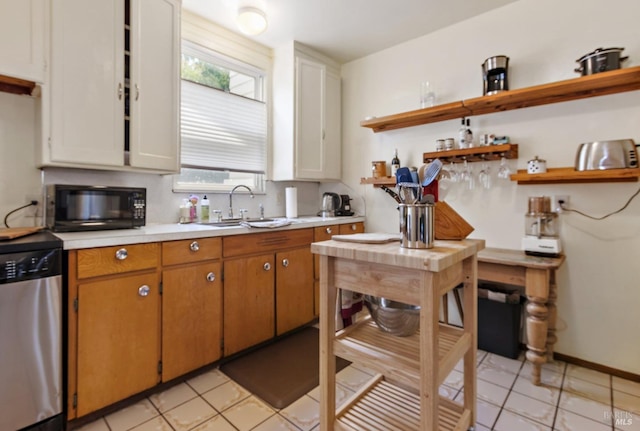 kitchen featuring black microwave, light tile patterned floors, light countertops, open shelves, and stainless steel dishwasher