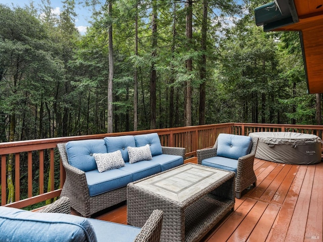 wooden terrace with an outdoor living space and a wooded view