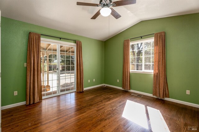 unfurnished room featuring baseboards, vaulted ceiling, a ceiling fan, visible vents, and wood finished floors