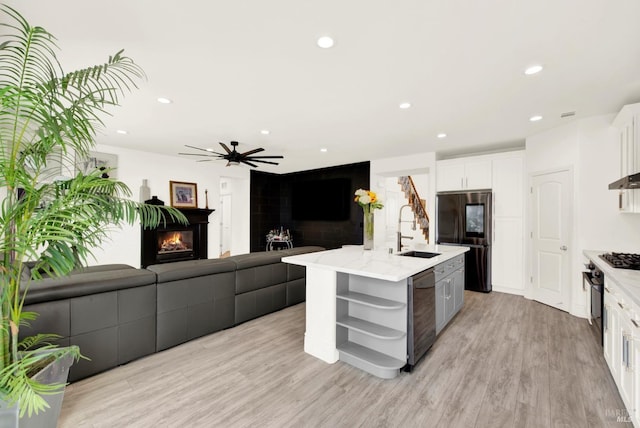 kitchen with open shelves, a lit fireplace, a sink, dishwasher, and smart refrigerator