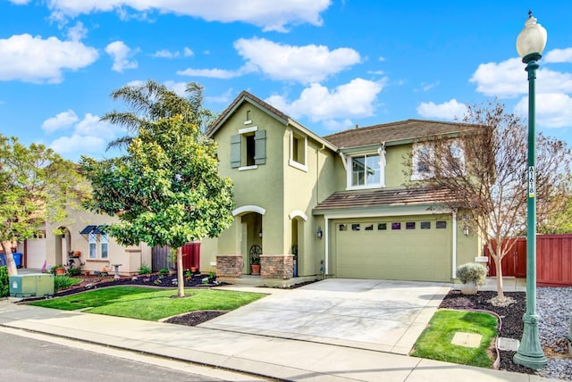 traditional-style house with driveway, stucco siding, fence, and a garage