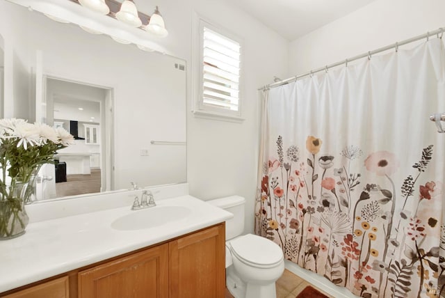 bathroom featuring vanity, toilet, tile patterned floors, visible vents, and curtained shower