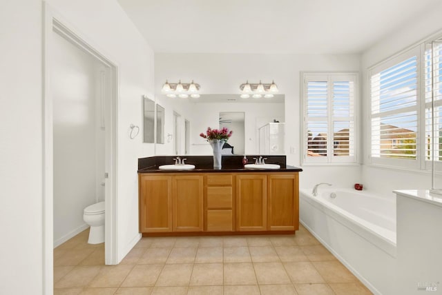 full bathroom featuring toilet, a sink, a shower stall, and a bath