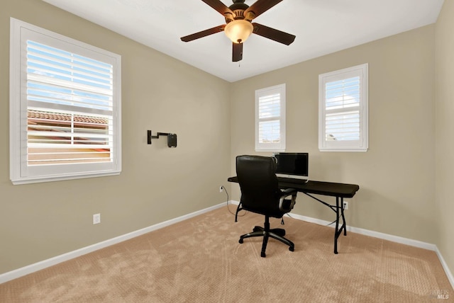 carpeted home office with baseboards and ceiling fan