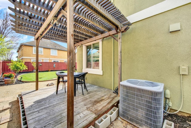 wooden terrace featuring central AC unit, outdoor dining area, fence, and a pergola