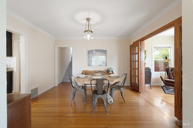 30 Buena Vista Ave, Vallejo, CA 94590 - dining space featuring light wood finished floors, stairs, crown molding, baseboards, and french doors