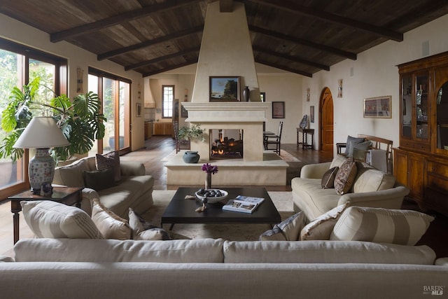 living room with arched walkways, wooden ceiling, beamed ceiling, and a fireplace