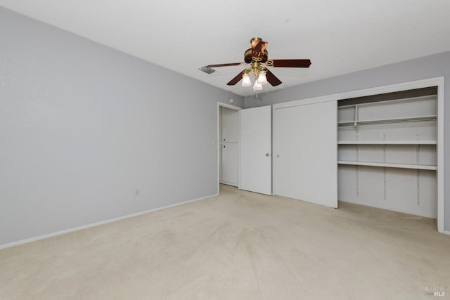 unfurnished bedroom with baseboards, light colored carpet, ceiling fan, and visible vents