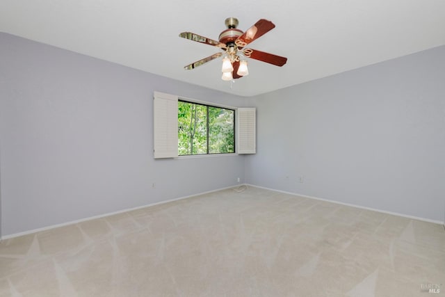 unfurnished room featuring baseboards, a ceiling fan, and light colored carpet