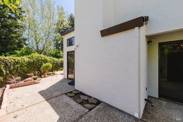 view of property exterior with a patio area and stucco siding