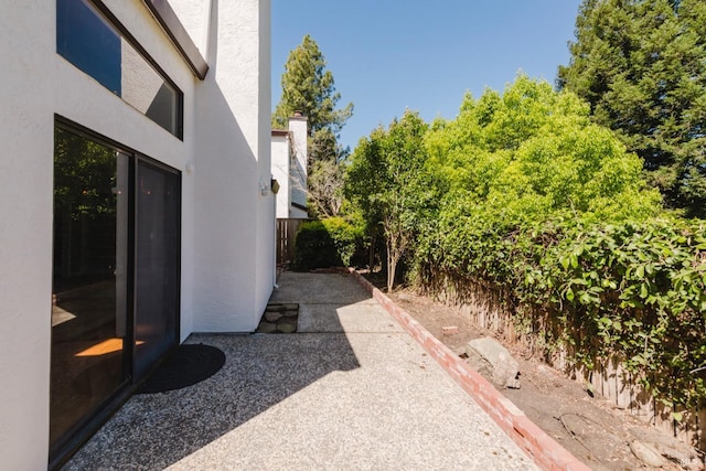 view of yard with fence and a patio