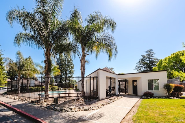 exterior space with a yard, fence, and a pool