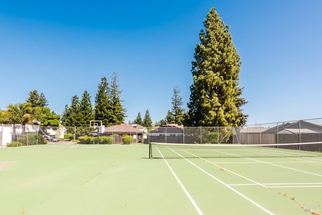 view of tennis court with fence