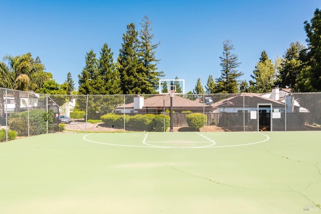 view of basketball court with community basketball court and fence