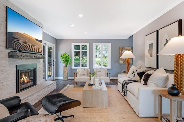 4071 Bones Rd, Sebastopol, CA 95472 - living area with crown molding, a large fireplace, wood finished floors, healthy amount of natural light, and recessed lighting