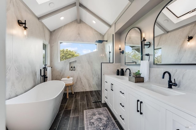 4071 Bones Rd, Sebastopol, CA 95472 - full bath with a freestanding bath, wood finish floors, tiled shower, a skylight, and tile walls
