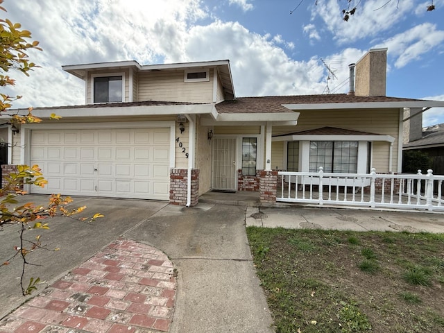 view of front of house featuring a garage, covered porch, a chimney, and concrete driveway