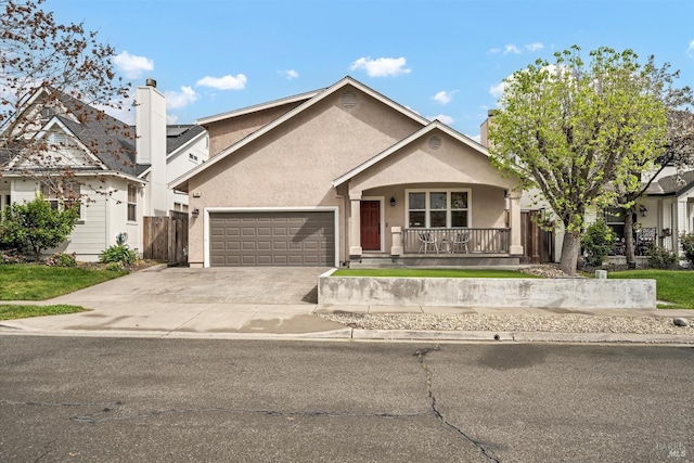 view of front of house featuring fence, a garage, concrete driveway, stucco siding, and a porch