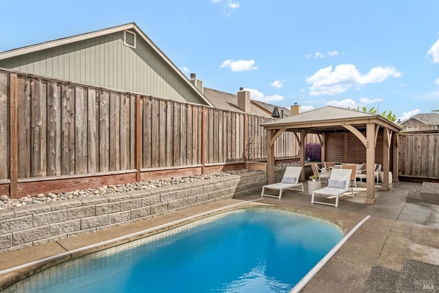 view of swimming pool featuring a patio, a fenced in pool, a fenced backyard, and a gazebo