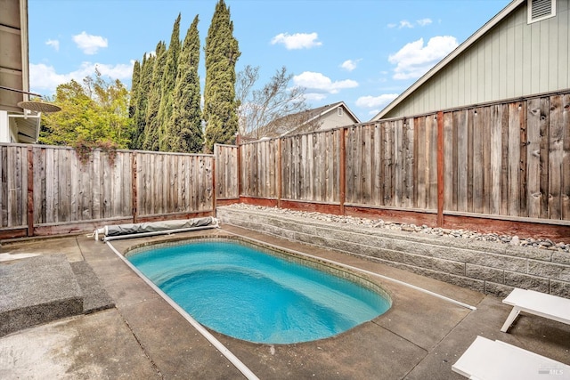 view of pool featuring a fenced backyard and a patio area