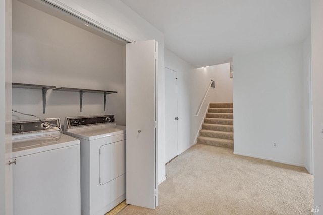 laundry room with independent washer and dryer, laundry area, and light carpet