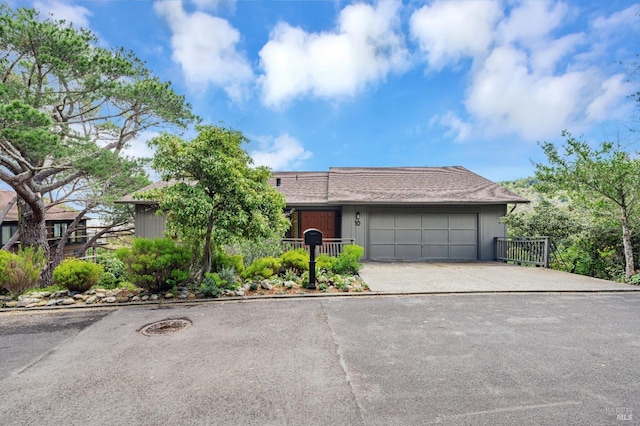 single story home featuring a garage and concrete driveway
