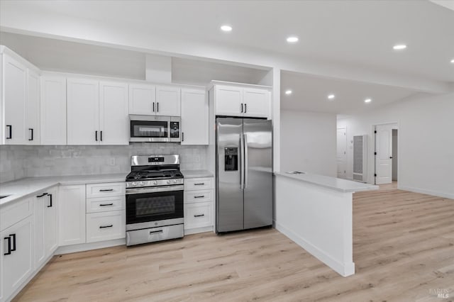 kitchen with recessed lighting, light wood finished floors, stainless steel appliances, decorative backsplash, and white cabinetry