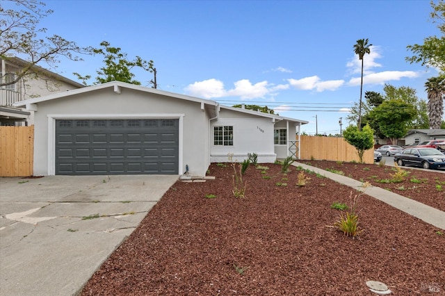 single story home with fence, stucco siding, driveway, and an attached garage