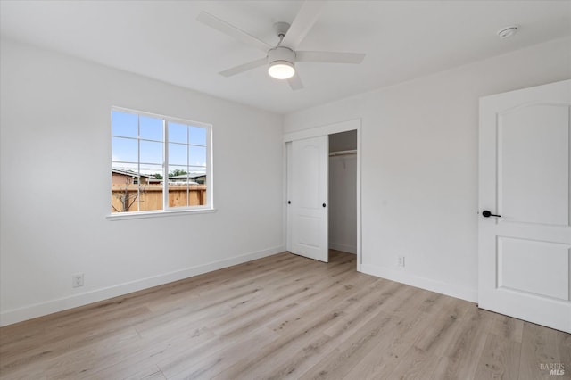unfurnished bedroom featuring a closet, a ceiling fan, wood finished floors, and baseboards