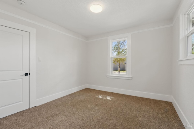 carpeted spare room with baseboards