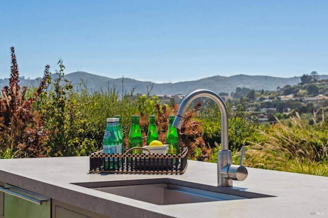 exterior space with a sink and a mountain view
