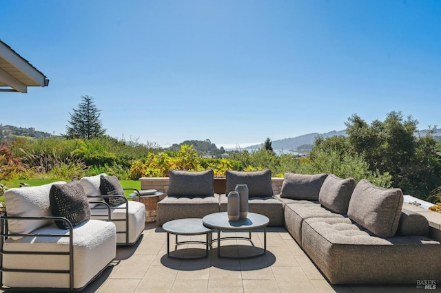 view of patio / terrace with an outdoor hangout area and a mountain view